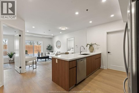 A modern kitchen with wooden cabinets and a large island.