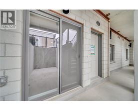 A glass door with a sign on the wall behind it.