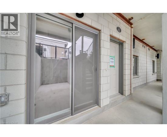A glass door with a sign on the wall behind it.