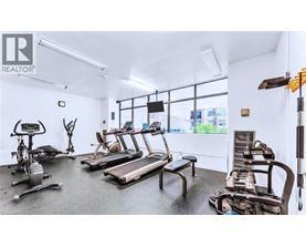 A gym with treadmills, exercise bikes, and weights.