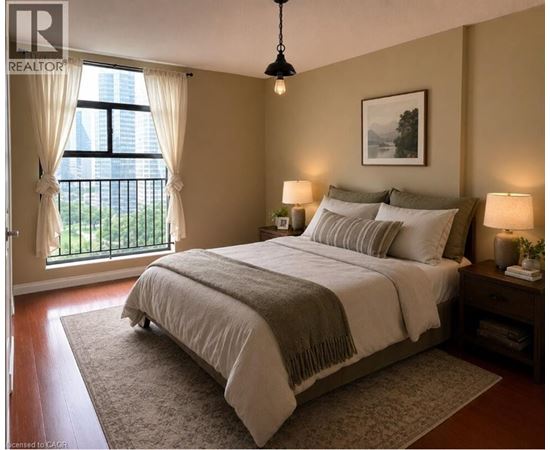 A bedroom with a large bed and a window with curtains.