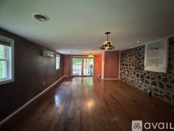 A room with wooden floors and a large window.
