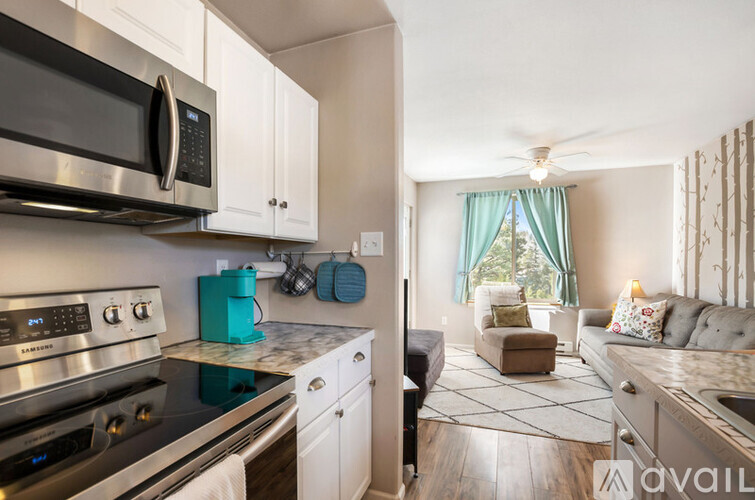 A kitchen with a stove top oven and microwave above it.