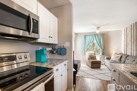 A kitchen with a stove top oven and microwave above it.
