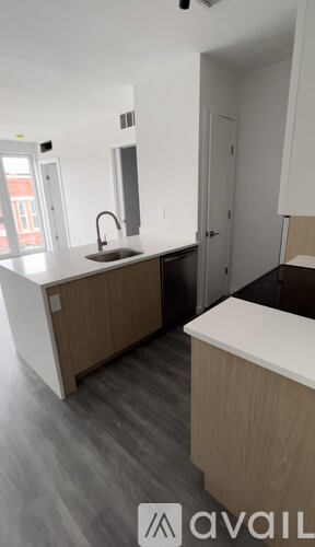 A modern kitchen with a sink and a counter.