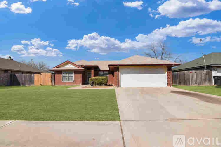 A house with a brown roof and a white garage door is for sale.