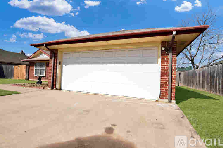 A detached house with a white garage door.