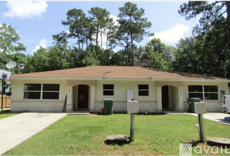 A house with a brown roof and a white garage door.