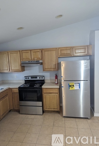 A kitchen with a stove, oven, and refrigerator.