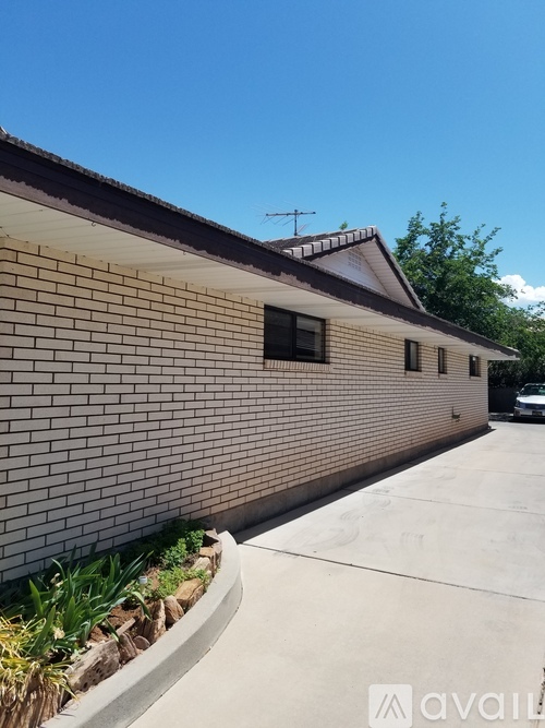 A building with a brown brick exterior and a white roof.