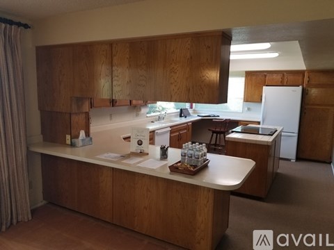 A kitchen with wooden cabinets and a white refrigerator.