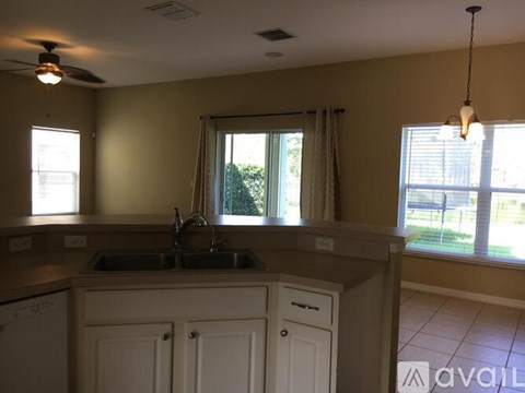 A kitchen with a sink and a window.