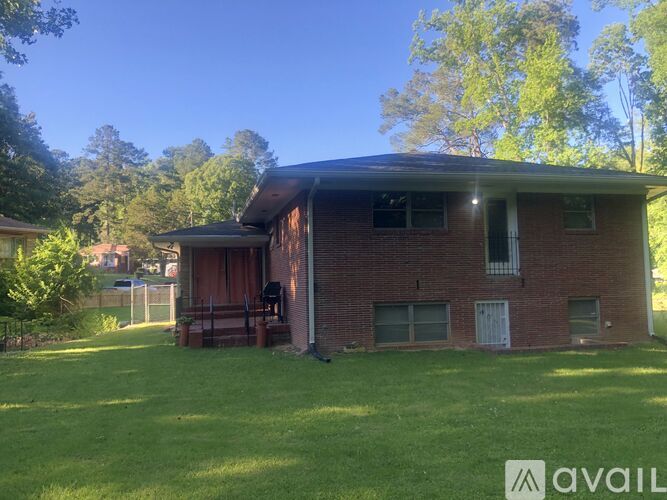 A house with a red brick exterior and a white door is for sale.