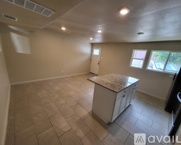 A kitchen with a countertop and cabinets is available for rent.