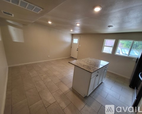A kitchen with a countertop and cabinets is available for rent.