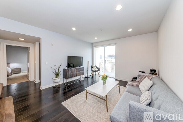 A living room with a grey couch and a wooden coffee table.