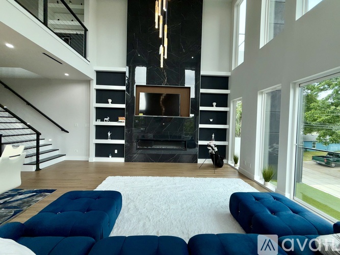 A modern living room with a blue sofa and a fireplace.