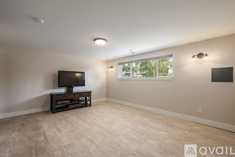 A living room with a flat screen TV on a wooden stand.