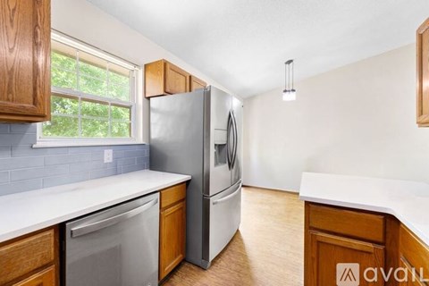 A kitchen with wooden cabinets and a white countertop.