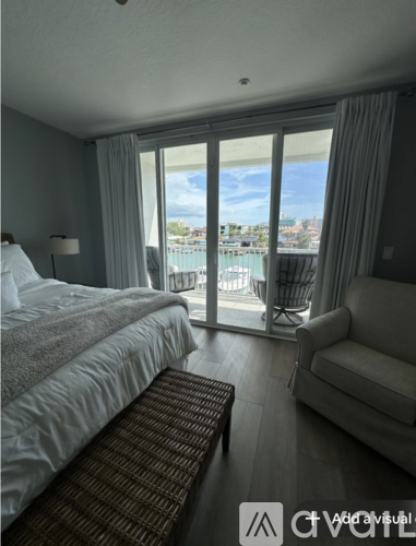 A bedroom with a large bed and a view of the city.