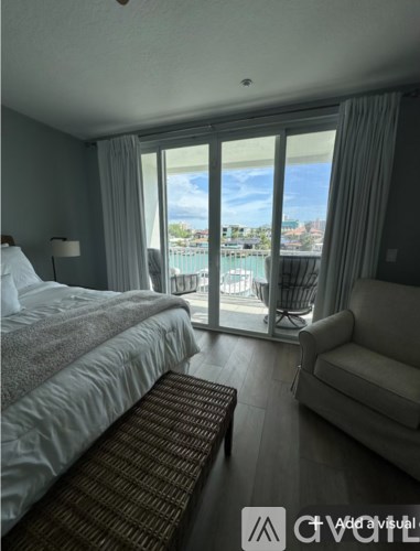 A bedroom with a large bed and a view of the city.