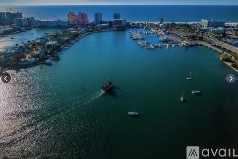 A marina with boats and buildings in the background.