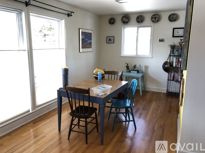A dining room with a table and chairs.
