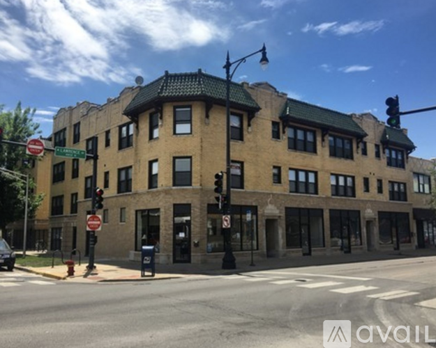 A street view of a building with a green roof and a stop sign in front of it.