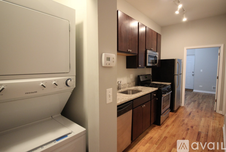 A kitchen with a white oven and a black fridge.