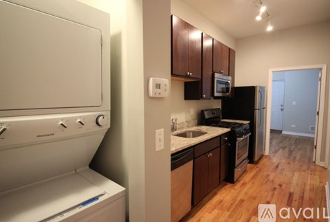 A kitchen with a white oven and a black fridge.