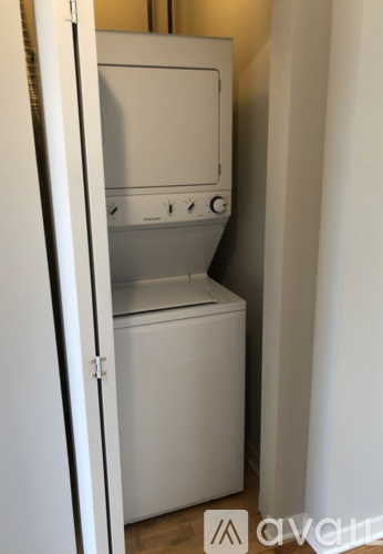A white fridge with a freezer drawer is in a room.
