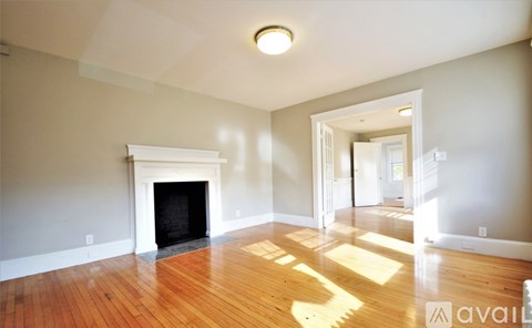 A room with a fireplace and wooden floors.