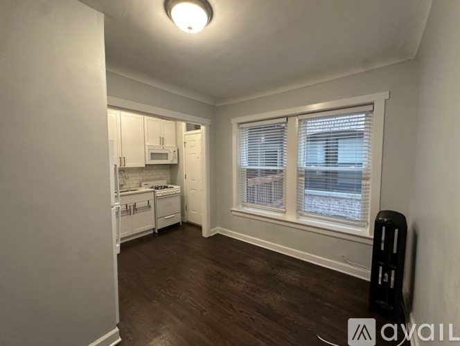 A small, empty room with a window and a radiator.