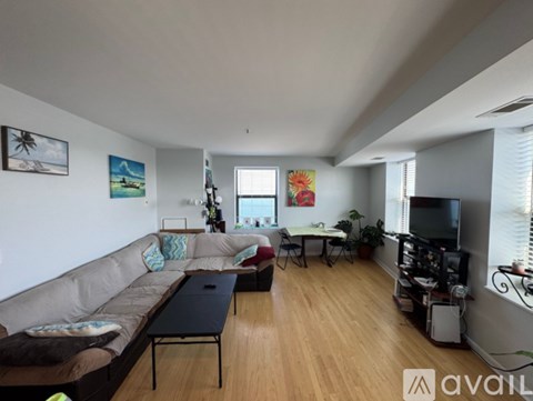 A living room with a grey sofa and a television.