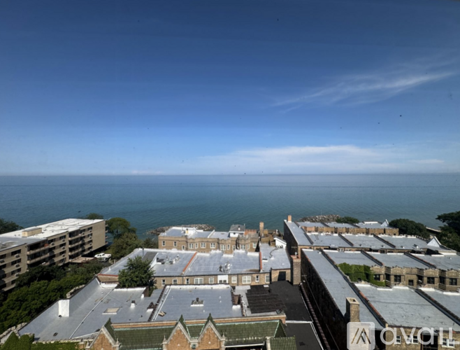 A view of a coastal town with buildings and a clear sky.