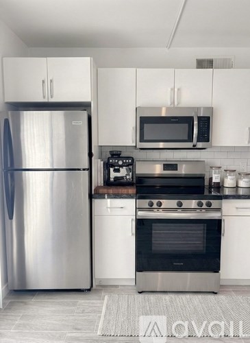 A kitchen with a stainless steel refrigerator and oven.
