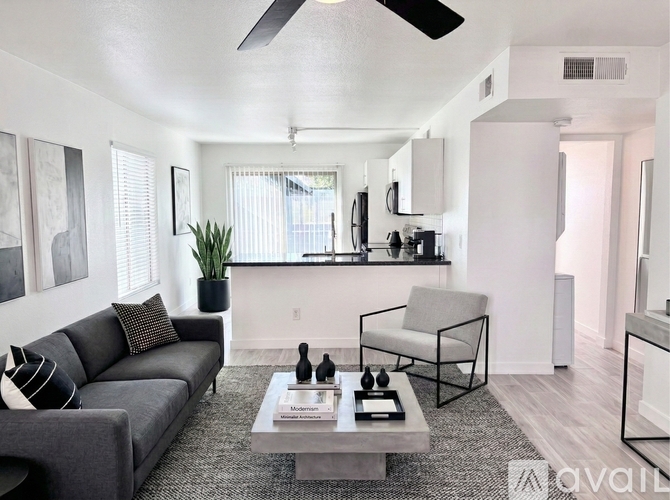 A living room with a grey couch and a coffee table.