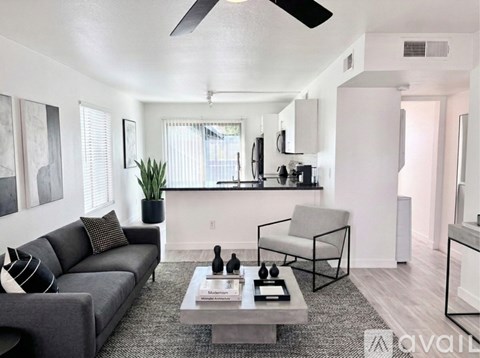 A living room with a grey couch and a coffee table.