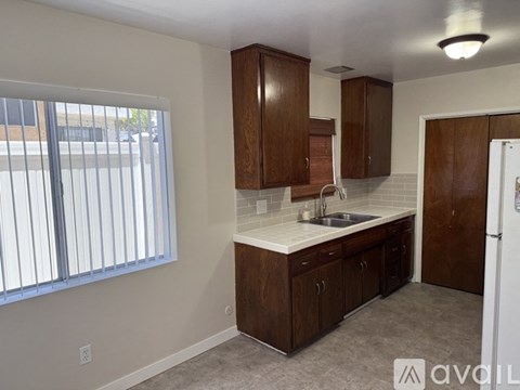 A kitchen with wooden cabinets and a white countertop.