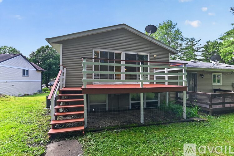A house with a deck and a red staircase.