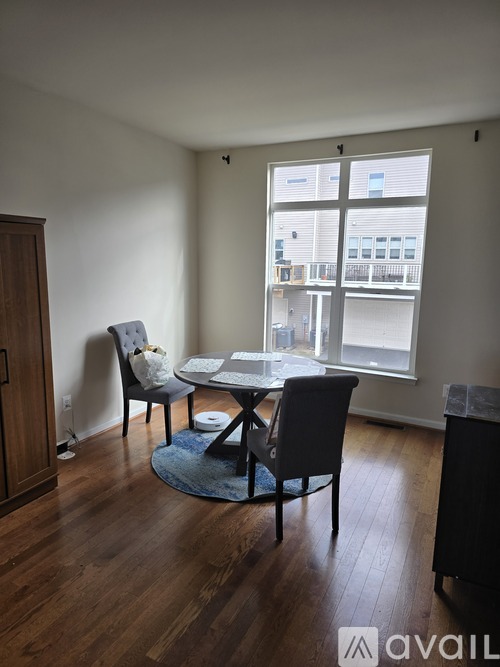 A dining room with a table and chairs.