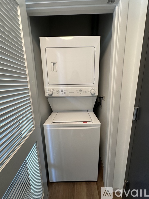 A white dishwasher and washing machine in a small space.