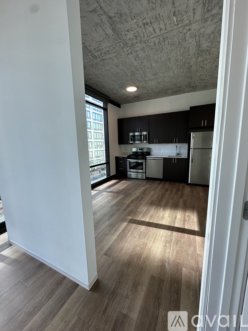 A kitchen with dark wood cabinets and a white wall.