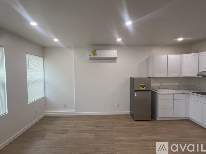 A kitchen with a refrigerator and cabinets.