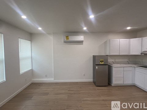 A kitchen with a refrigerator and cabinets.