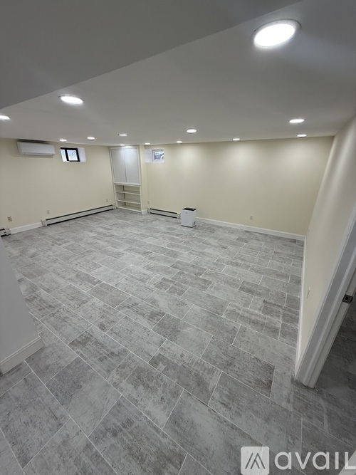 A room with a grey floor and white walls.