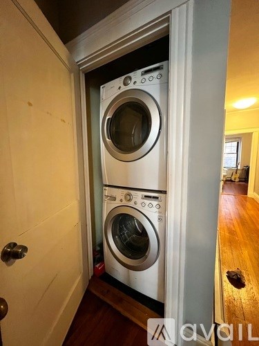 A white washing machine is in a doorway.