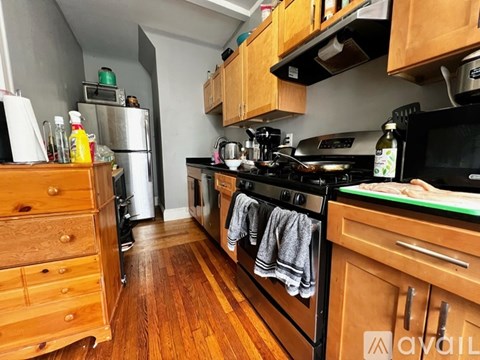A kitchen with wooden cabinets and a black stove top.