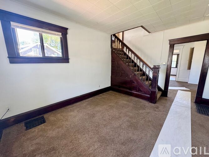 A room with a staircase and a window.