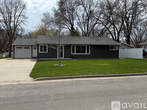 A two-story house with a garage is available for rent.